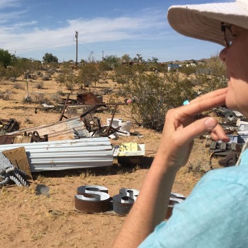 Artist Cathy Allen contemplates a boneyard at Noah Purifoy's Outdoor Museum