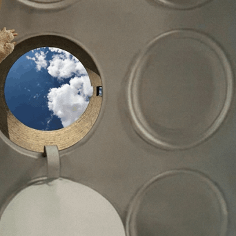 An round opening reveals the sky view through a silo structure